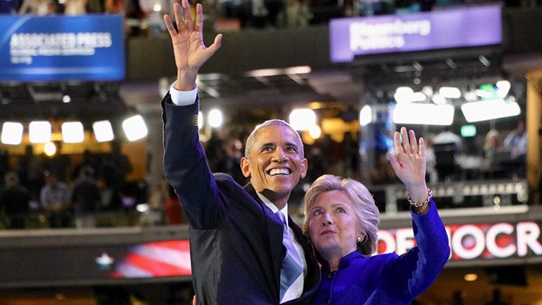 President Barack Obama and Democratic presidential nominee Hillary Clinton waving to the crowd as they exit the stage. (Evan Garcia / Chicago Tonight)