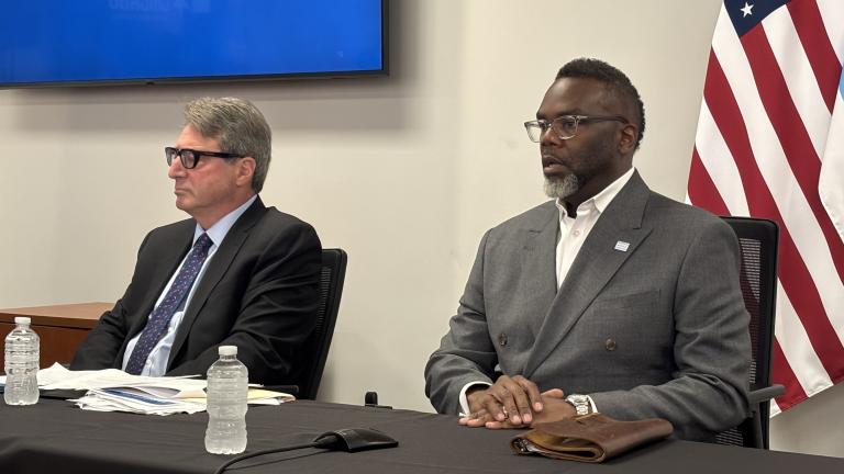 Mayor Brandon Johnson (right), flanked by acting Comptroller Michael Belsky (left), addresses the news media on Tuesday, July 1, 2025. (Heather Cherone / WTTW News)