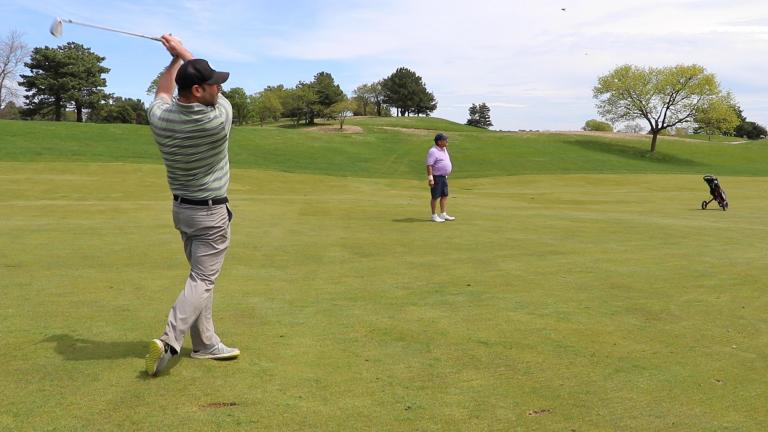 Golfer Danny Steinberg follows through on a shot at the Glen Club, an 18-hole semi-private golf course in Glenview. The suburban club was one of several courses in Illinois that reopened May 1 under specific social distancing guidelines. (Evan Garcia / WTTW News)