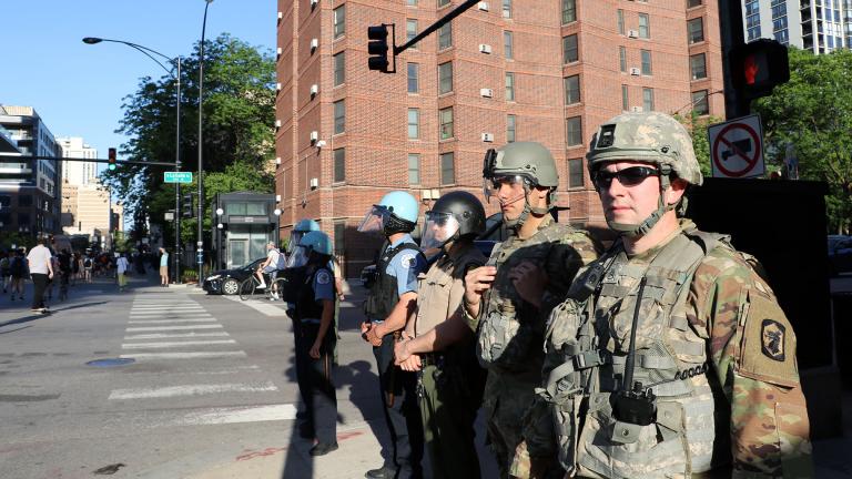 Illinois National Guard officers watch a protest in Old Town on June 6, 2020, one of many in the city and across the U.S. sparked by the death of George Floyd while in Minneapolis police custody. (Evan Garcia / WTTW News)