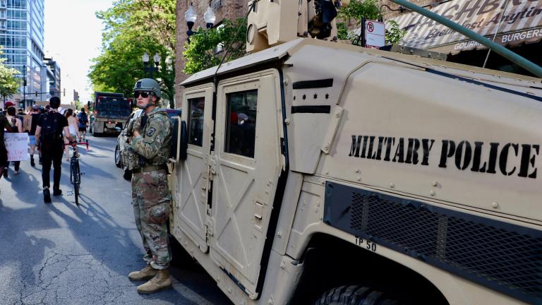 An Illinois National Guard officer watches a protest along Wells Street on June 6, 2020. The march was one of many in the city and across the U.S. sparked by the death of George Floyd while in Minneapolis police custody. (Evan Garcia / WTTW News)