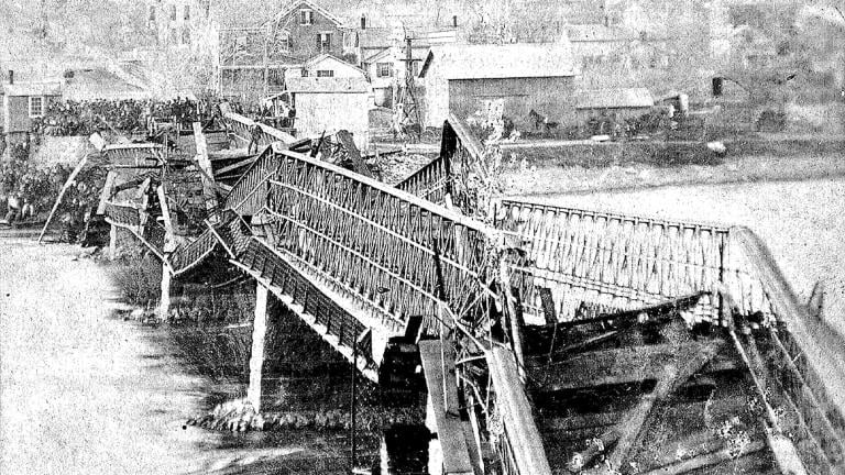 This photo provided by Lee County Historical and Genealogical Society shows the Truesdell Bridge in Dixon, Ill., in 1873. On May 4, 1873, a crowd of more than 200 gathered on the bridge to watch a baptism when it toppled over, trapping dozens of victims just inches below the river's surface. (Charles Keyes / Lee County Historical and Genealogical Society via AP)