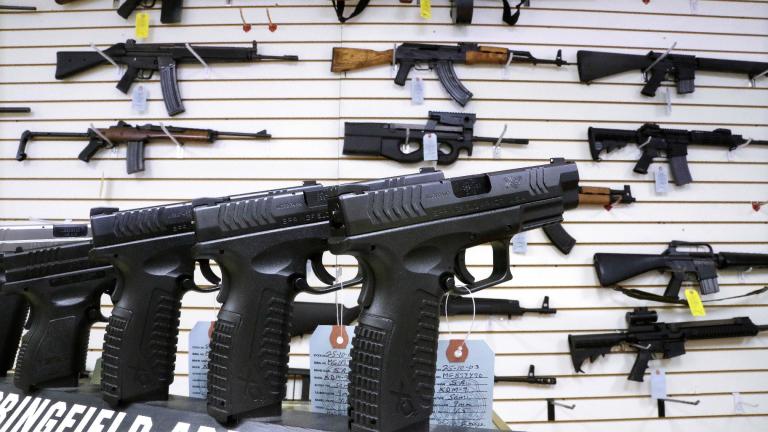 Semi-automatic guns are displayed for sale at Capitol City Arms Supply, Jan. 16, 2013, in Springfield, Ill. (AP Photo / Seth Perlman, File)