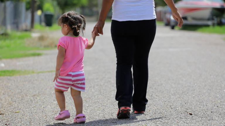 In this Sept. 16, 2015, photo, a woman in Sullivan City, Texas, who said she entered the country illegally, walks with her daughter who was born in the United States, but was denied a birth certificate. (AP Photo / Eric Gay, File)