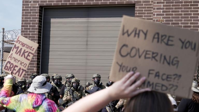 People protest outside of an immigration facility guarded by federal agents Friday, Sept. 12, 2025, in in Broadview, Ill. (AP Photo/Laura Bargfeld)