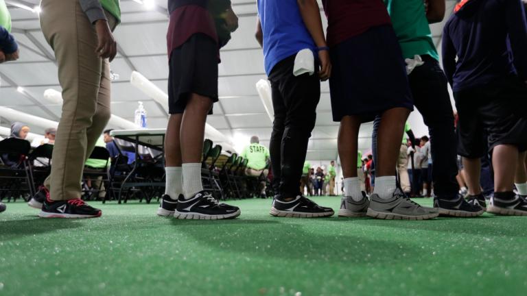 In this July 9, 2019, file photo, immigrants line up in the dining hall at the U.S. government's newest holding center for migrant children in Carrizo Springs, Texas. (AP Photo / Eric Gay, File)