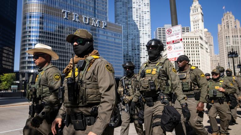 Federal agents from U.S. Immigration and Customs Enforcement and U.S. Customs and Border Protection walk along West Wacker Drive in the Loop, Sunday, Sept. 28, 2025, in Chicago. (Ashlee Rezin / Chicago Sun-Times via AP)