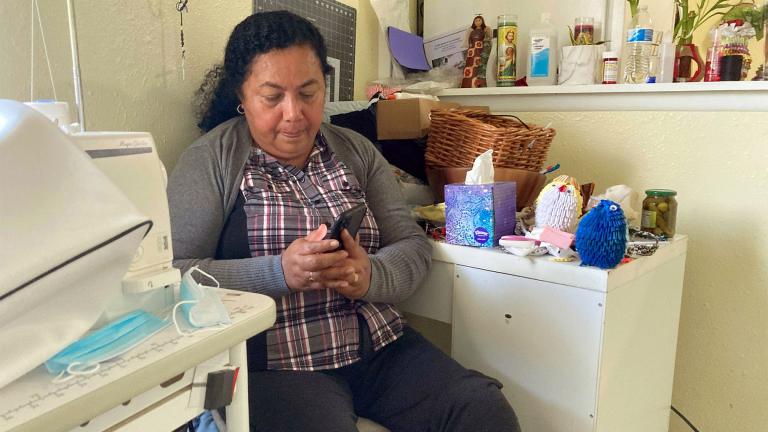 Rosalidia Dardon, 54, looks at a picture of her daughter in El Salvador as she sits in a refugee house in Texas, awaiting asylum or a protected immigration status on Nov. 4, 2021. (Acacia Coronado / Report for America via AP) Rosalidia Dardon, 54, looks at a picture of her daughter in El Salvador as she sits in a refugee house in Texas, awaiting asylum or a protected immigration status on Nov. 4, 2021. (Acacia Coronado / Report for America via AP)