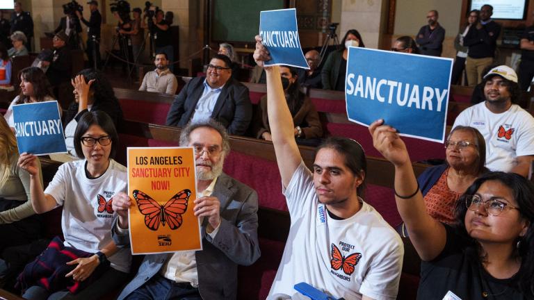 Members of immigration advocacy groups react as Los Angeles City Council votes to enact an ordinance to prohibit city resources from being used for immigration enforcement in anticipation of potential mass deportations under President-elect Donald Trump, inside Los Angeles City Hall on Tuesday, Nov. 19, 2024. (AP Photo / Damian Dovarganes, File)