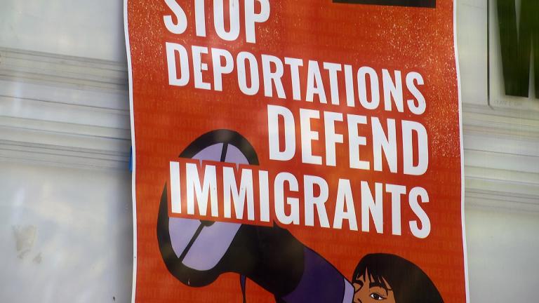 A sign reads "Stop Deportations Defend Immigrants" on Chicago's Northwest Side. (WTTW News)