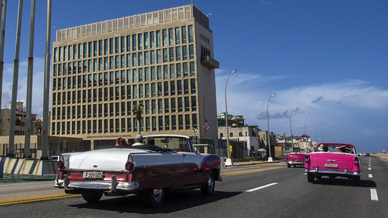In this Oct. 3, 2017, file photo, tourists ride classic convertible cars on the Malecon beside the United States Embassy in Havana, Cuba. (AP Photo / Desmond Boylan, File)