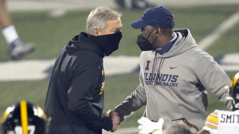 Iowa head coach Kirk Ferentz, left, and Illinois head coach Lovie Smith shakes hands after an NCAA college football game Saturday, Dec. 5, 2020, in Champaign, Ill. Iowa won 35-21. (AP Photo / Charles Rex Arbogast)