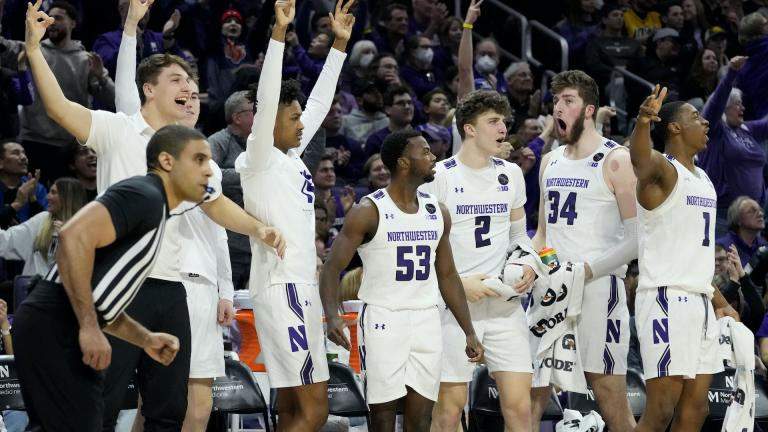 Northwestern players celebrate after guard Ty Berry scored a 3-point basket during the second half of the team's NCAA college basketball game against Iowa in Evanston, Ill., Sunday, Feb. 19, 2023. (AP Photo/Nam Y. Huh)