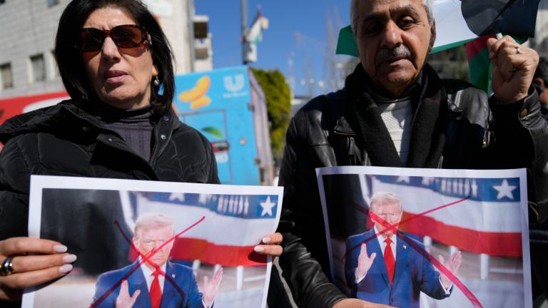 Palestinians carry defaced pictures of U.S. President Donald Trump while protesting against his latest statements regarding the transfer of Palestinians from Gaza, in the West Bank city of Ramallah Wednesday, Jan. 29, 2025. (AP Photo / Nasser Nasser)