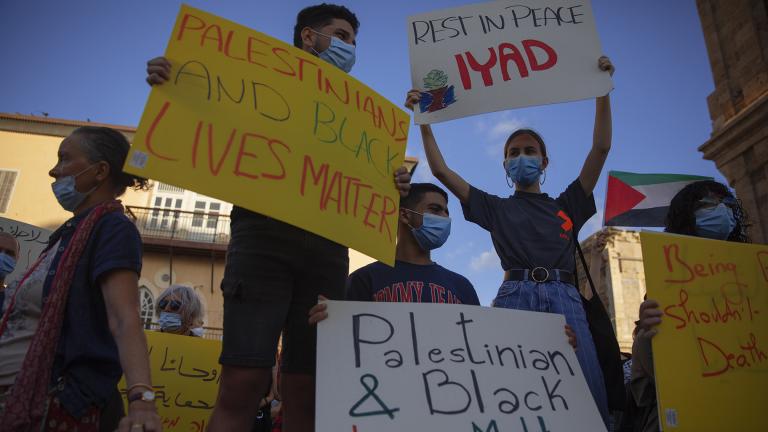 Protesters hold signs during a demonstration against the Israeli police after border police officers shot and killed Iyad al-Halak, an unarmed autistic Palestinian man, in the mixed Arab Jewish city of Jaffa, near Tel Aviv, Israel, after saying they suspected he was carrying a weapon, Sunday, May 31, 2020. Protesters gathered to protest the killing of al-Halak in Jerusalem and the killing of George Floyd in Minneapolis last week. (AP Photo / Oded Balilty)