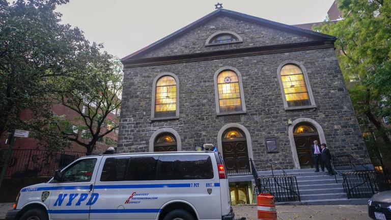 An NYPD patrol car is parked outside a synagogue on the Lower East Side of Manhattan, Saturday, Oct. 7, 2023. (AP Photo/Mary Altaffer)