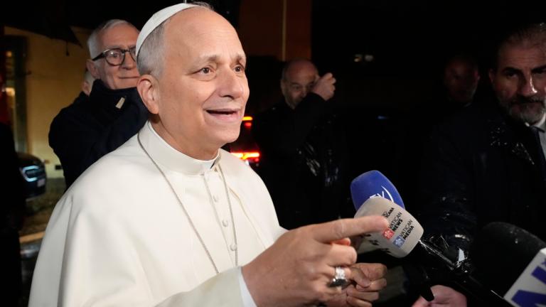 Pope Leo XIV talks to journalists as he leaves the Castel Gandolfo residence to head to the Vatican, Tuesday, Dec. 23, 2025. (AP Photo / Gregorio Borgia)