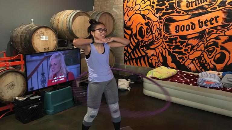 Wicker Park resident Jenny Doan poses for a picture Saturday Nov. 23 as she nears the end of her Guinness World Record attempt for longest marathon hula-hooping session. (Kristen Thometz / WTTW News)