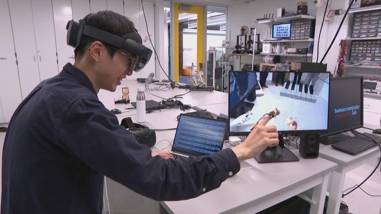 A student works in the Human-Computer Integration Lab at the University of Chicago. (WTTW News)