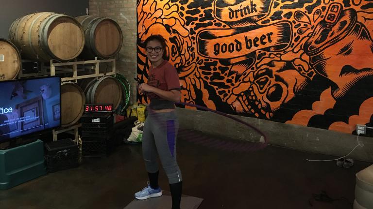 Wicker Park resident Jenny Doan hula-hoops at District Brew Yards. (Kristen Thometz / WTTW News)