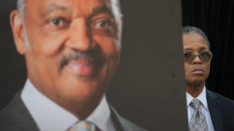 Jesse Jackson Jr. stands near a picture of his father, the Rev. Jesse Jackson, during a news conference outside the family home Wednesday, Feb. 18, 2026, in Chicago. (AP Photo / Erin Hooley)