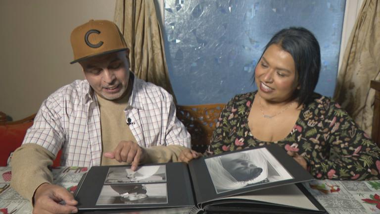 Jimmy Soto and his sister, Pilar More, look at family photos. (WTTW News)