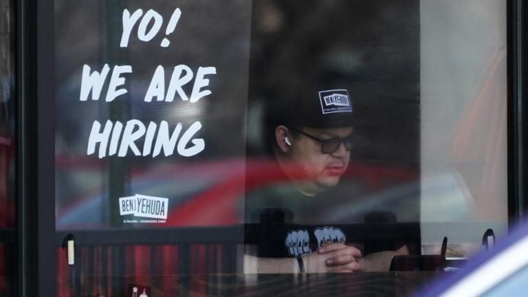 A hiring sign is displayed at a restaurant in Schaumburg, Ill., April 1, 2022. The white-hot demand for U.S. workers cooled a bit in April, though the number of unfilled jobs remains high and companies are still desperate to hire more people. (AP Photo/Nam Y. Huh, file)