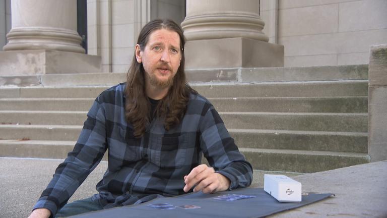 Jon Martin shows WTTW News some of his coin collection in Rogers Park. (WTTW News)
