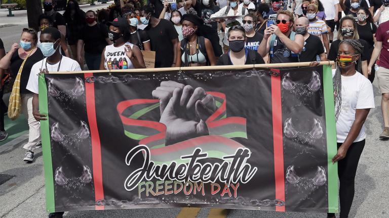 FILE - In this June 19, 2020, file photo, demonstrators march through downtown Orlando, Fla., during a Juneteenth event.  (AP Photo / John Raoux, File)