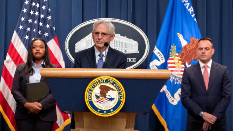 Attorney General Merrick Garland, center, is flanked by Principal Deputy Assistant Attorney General Doha Mekki, left, and Principal Deputy Associate Attorney General Benjamin Mizer, right, as he speaks during a news conference at the Department of Justice, Tuesday, Sept. 24, 2024, in Washington. (Mark Schiefelbein / AP Photo)