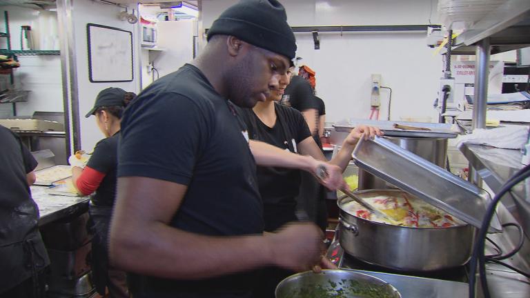 Brandon Johnson works in the kitchen at Chicago restaurant the Girl and the Goat. (Chicago Tonight)