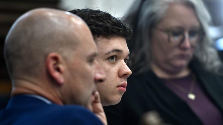 Kyle Rittenhouse, center, looks up and away from a video monitor as footage of him shooting on the night of Aug. 25, 2020, is shown during the trial at the Kenosha County Courthouse in Kenosha, Wis., on Wednesday, Nov. 3 2021. (Sean Krajacic / The Kenosha News via AP, Pool)