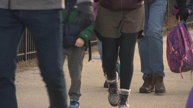 Children walking down a sidewalk. (WTTW News)