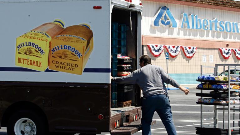 Mitch Maddox, a bread route salesman, loads bread Tuesday, May 30, 2006, outside the Eagle Rock Albertsons store in Los Angeles. The Federal Trade Commission on Monday, Feb. 16, 2024, sued to block a proposed merger between grocery giants Kroger and Albertsons, saying the $24.6 billion deal would eliminate competition and lead to higher prices for millions of Americans. (AP Photo / Damian Dovarganes, File)