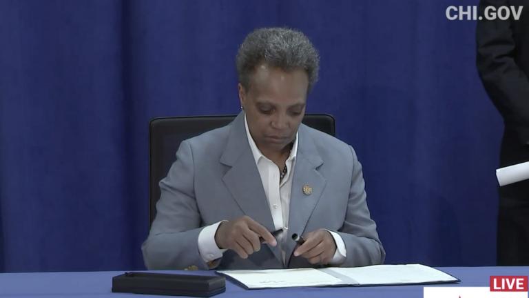 Mayor Lori Lightfoot signs an executive order ensuring all Chicago residents have equal access to COVID-19 aid programs regardless of citizenship status on Tuesday, April 7, 2020. (Chicago Mayor’s Office / Facebook photo) Mayor Lori Lightfoot signs an executive order ensuring all Chicago residents have equal access to COVID-19 aid programs regardless of citizenship status on Tuesday, April 7, 2020. (Chicago Mayor’s Office / Facebook photo)