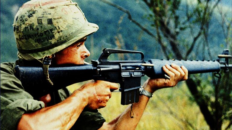 Recon by Fire, 1967. A member of the U.S. Army 101st Airborne Brigade in Quảng Ngãi Province uses his M16 rifle to conduct reconnaissance by fire. Photo by Specialist 5 Robert C. Lafoon, U.S. Army.