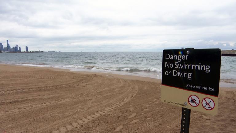 A Chicago beach sign warns people against swimming or diving in Lake Michigan. (WTTW News)
