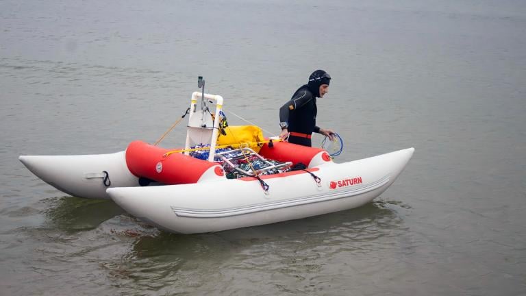 Jim Dreyer heads out into Lake Michigan in Grand Haven, Mich., Aug. 6, 2024, in his attempt to swim to Wisconsin. (Blace Carpenter / The Tribune via AP)