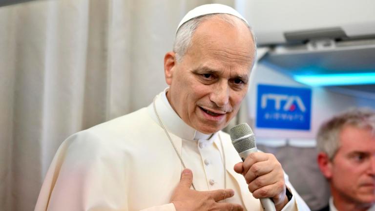 Pope Leo XIV talks to reporters aboard an airplane as he returns from a six-day visit to Turkey and Lebanon, Tuesday, Dec. 2, 2025. (Alessandro Di Meo / Pool Photo via AP)