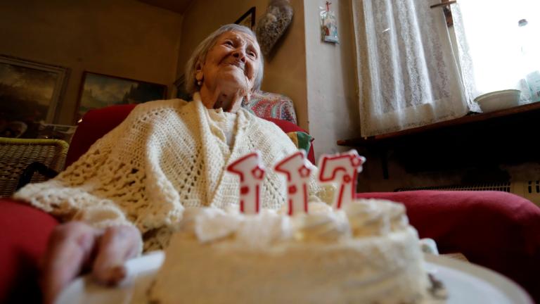 FILE- Emma Morano holds a cake with candles marking 117 years on the day of her birthday, Nov. 29, 2016, in Verbania, Italy. (Antonio Calanni / AP Photo)