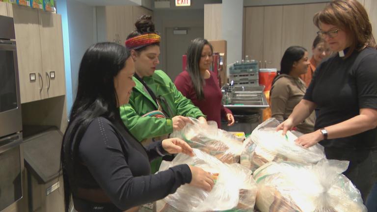 Each morning, a group of volunteers and migrants sheltering at Luther Memorial Church in Lincoln Square prepare meals and hot coffee to go. (WTTW News)