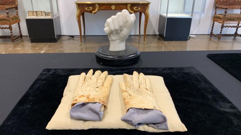A pair of stained leather gloves carried by Abraham Lincoln at Ford's Theatre the night of his assassination that sold for $1.2 million is pictured on May 19, 2025. (Eunice Alpasan / WTTW News)
