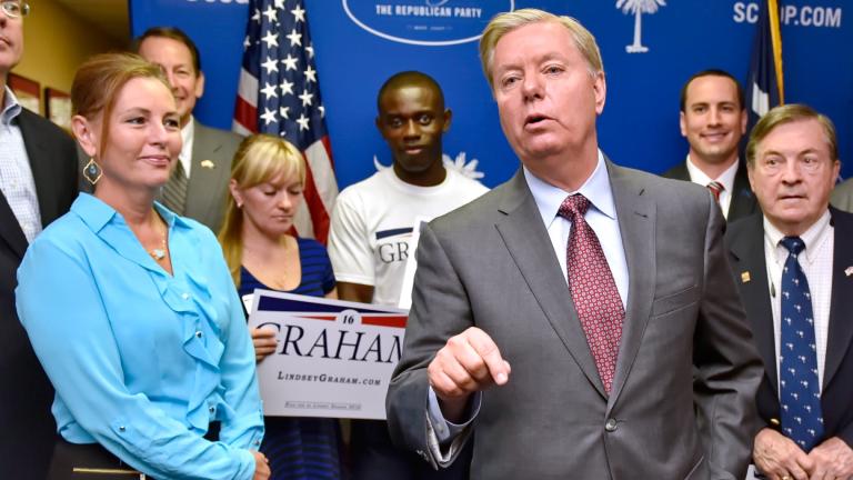 Republican presidential candidate, Sen. Lindsey Graham, R-S.C., accompanied by his sister Darline, left, speaks at the GOP headquarters in Columbia, S.C., Sept. 1, 2015, where he filed for the South Carolina Presidential Primary. (AP Photo / Richard Shiro, File)