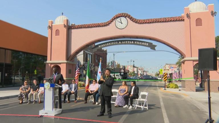 Community members and city officials gathered underneath the Little Village Arch on Sept. 11, 2024 to celebrate its restoration. (WTTW News)