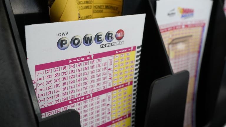 In this Jan. 12, 2021 file photo, blank forms for the Powerball lottery sit in a bin at a local grocery store, in Des Moines, Iowa. (AP Photo / Charlie Neibergall)