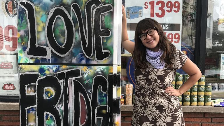 Allie Mae Miller stands next to the refrigerator she painted and donated to the Love Fridge project in Avondale. (Ariel Parrella-Aureli / WTTW News)