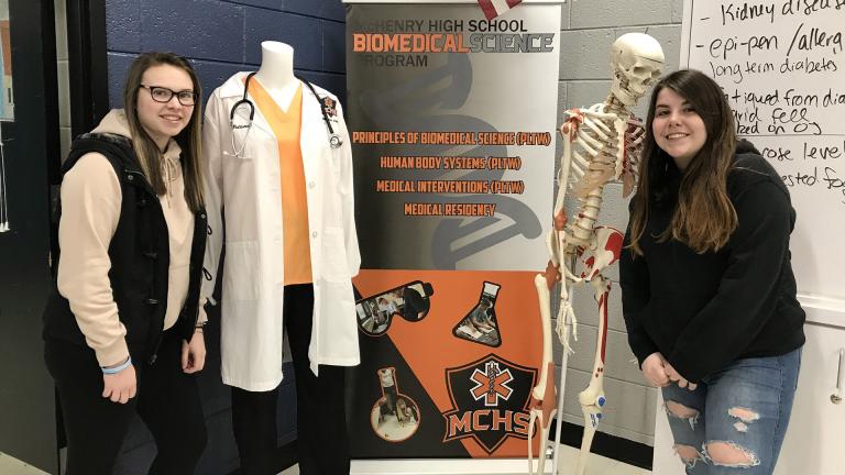 Sarah Touhy, left, a 2019 graduate of McHenry High School’s East Campus and Breanna Darcy, a senior at McHenry High School’s West Campus, pose for a picture on Jan. 15 in the biomedical science classroom at the east campus. (Courtesy of McHenry High School) Sarah Touhy, left, a 2019 graduate of McHenry High School’s East Campus and Breanna Darcy, a senior at McHenry High School’s West Campus, pose for a picture on Jan. 15 in the biomedical science classroom at the east campus. (Courtesy of McHenry High School)