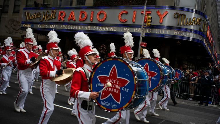 Revelers makes their way down the Avenue of the Americas in front of Radio City Music Hall during the Macy's Thanksgiving Day Parade in New York on Nov. 28, 2019. (AP Photo / Eduardo Munoz Alvarez, File)