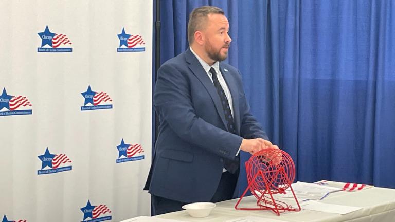 Max Bever of the Chicago Board of Election Commissioners conducts a lottery on Dec. 6, 2022, to determine the order of candidates in the Feb. 28 election. (Heather Cherone/WTTW News)