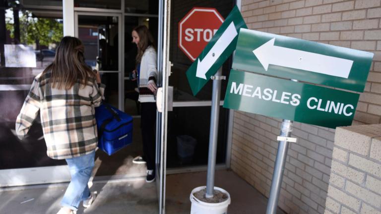 Health department staff members enter the Andrews County Health Department measles clinic carrying doses of the measles, mumps and rubella vaccine, April 8, 2025, in Andrews, Texas. (AP Photo / Annie Rice, File)